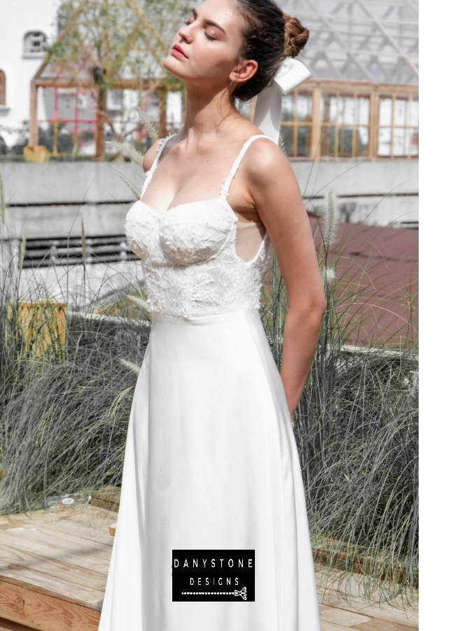A full-length back view of the elegant satin dress highlighting the lace bodice and satin skirt.