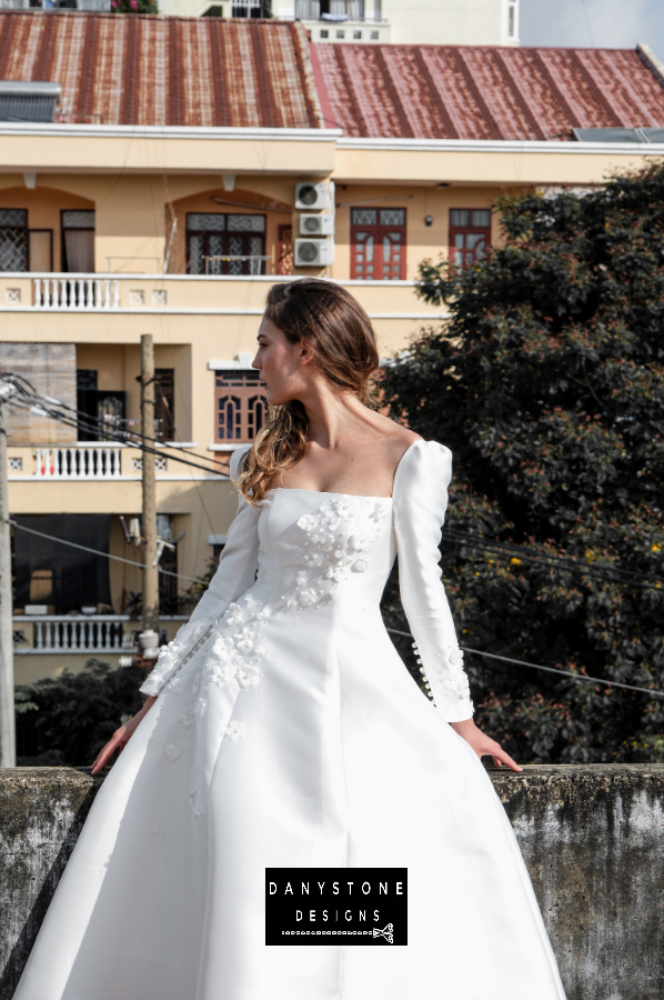 A side view of the elegant 7-piece tafta dress showcasing the embossed flowers and long sleeves.