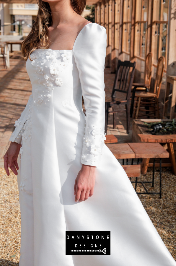Model posing in the 7-piece tafta dress with embossed flowers, highlighting the details.