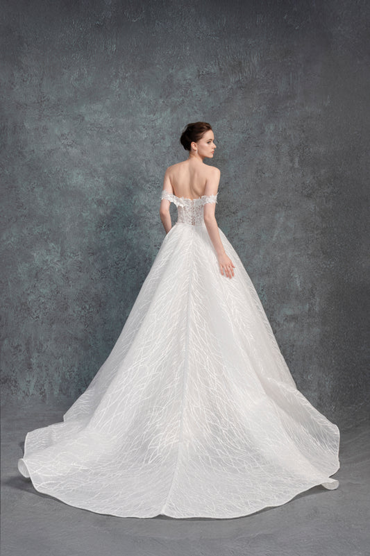 White wedding dress with intricate detailing on a gray background