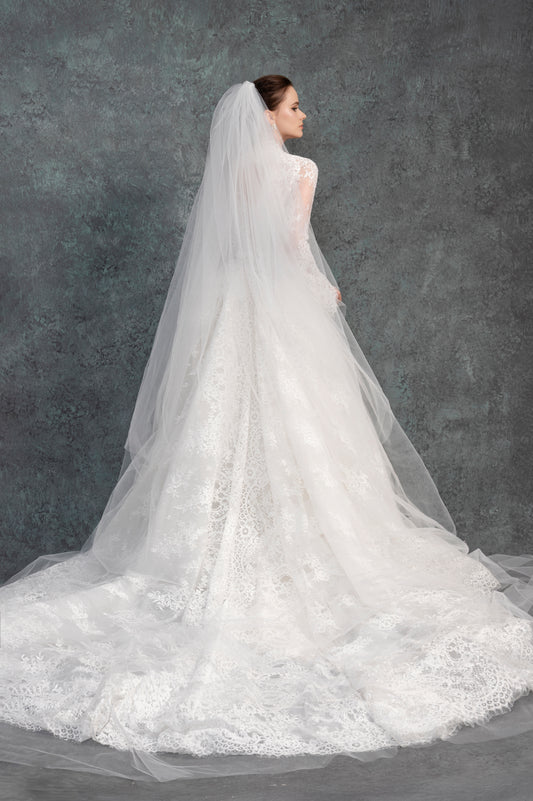 White wedding dress with a long veil against a dark background