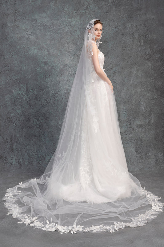 White wedding dress with a long veil on a dark gray background