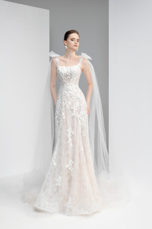 White wedding dress with floral details on a plain background