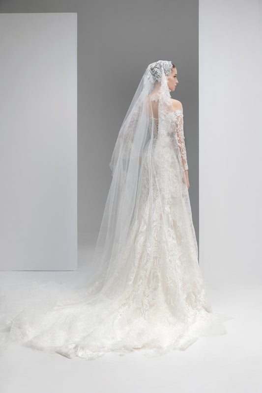 Elegant wedding dress with a long veil on a plain background