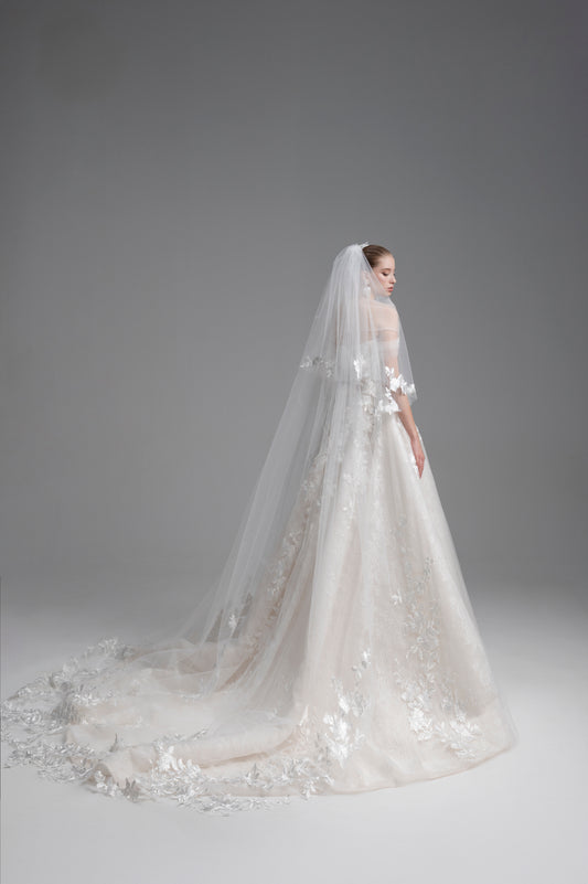 Elegant wedding dress with a long veil on a plain background