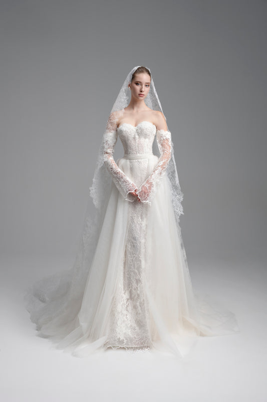 White wedding dress with lace detailing on a gray background