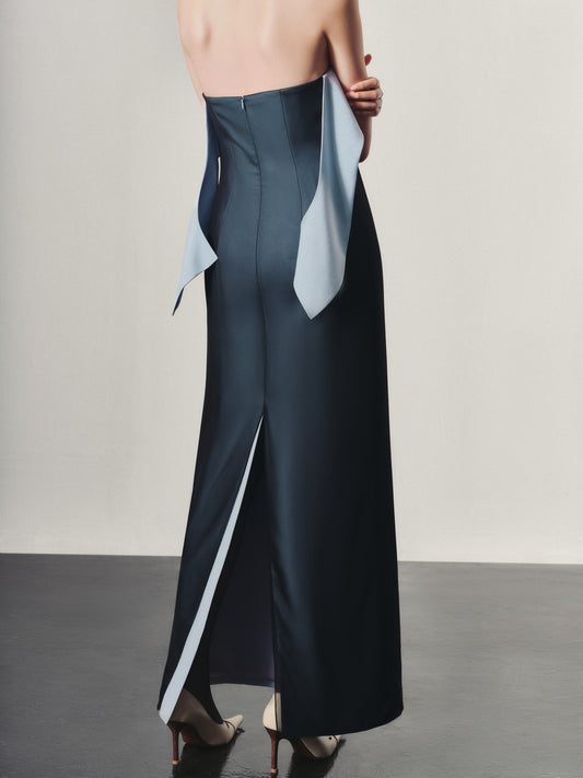 Long dark blue skirt with light blue lining worn by a person on a plain background