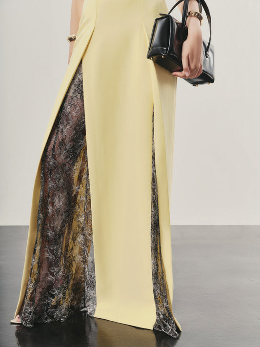 Yellow pants with lace detailing on a plain background