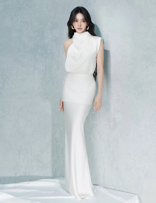 Woman wearing a white sleeveless dress against a light gray background