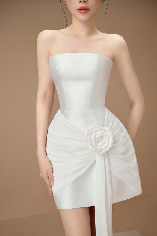 White strapless dress with a floral detail on a brown background