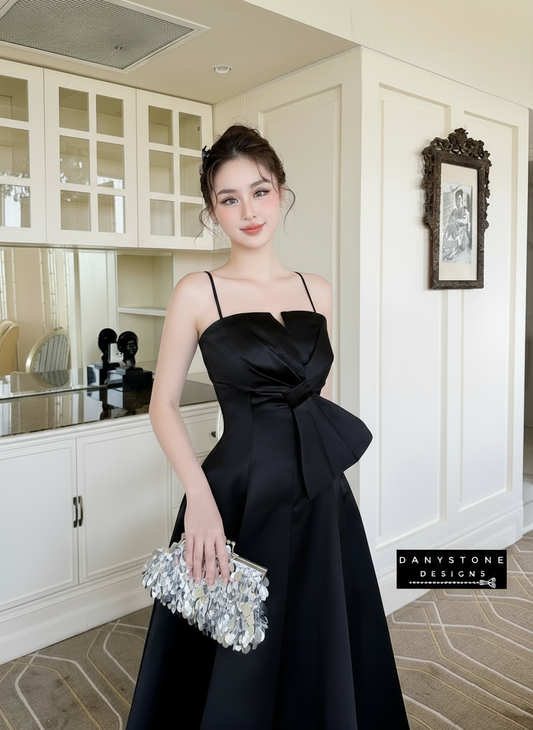 Model in Black 2-Strap Bow Accent Dress in Elegant Room