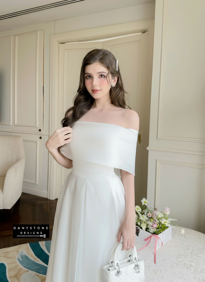 Model in White Off-Shoulder Party Dress in Sophisticated Setting