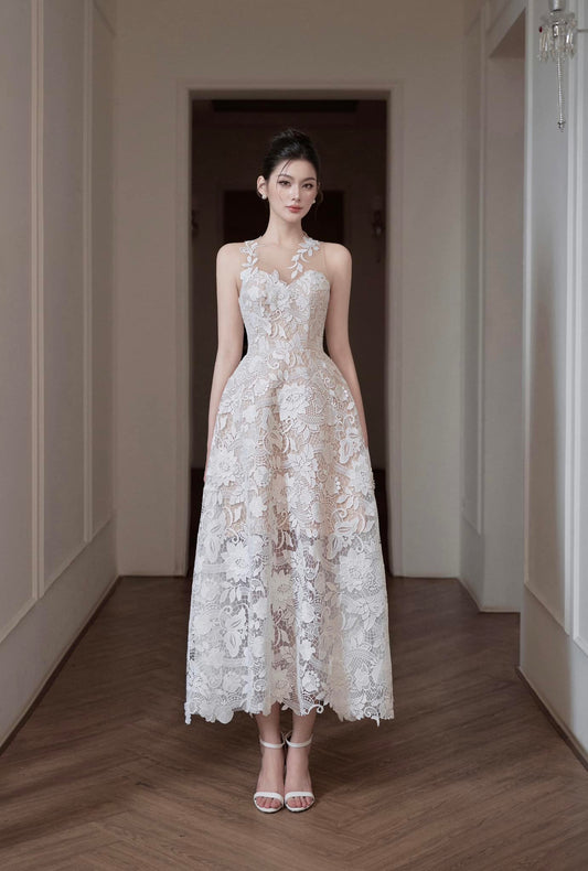 Woman in a white lace dress standing in a hallway