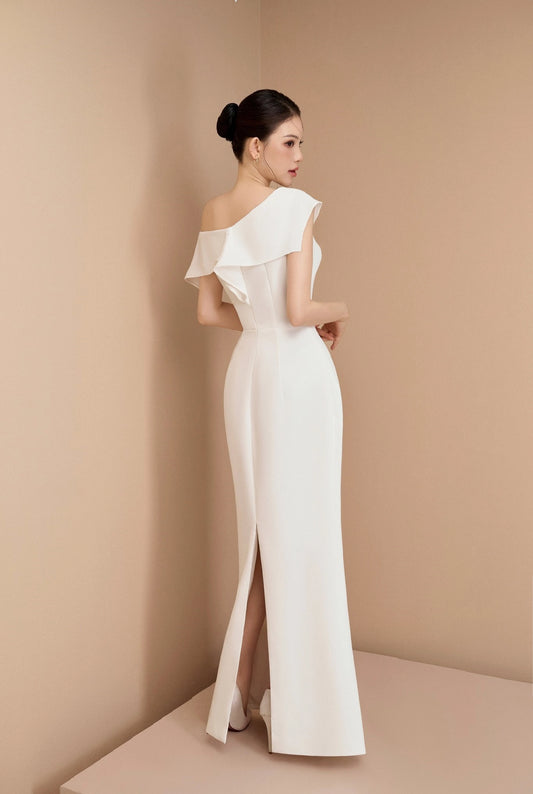 Woman wearing a white off-shoulder gown against a beige background