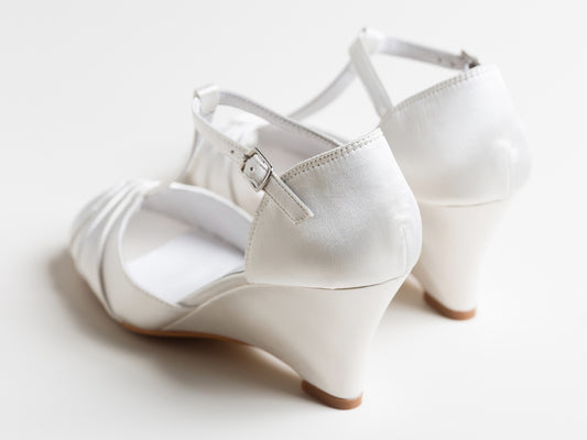 White wedding shoes with a strap on a white background
