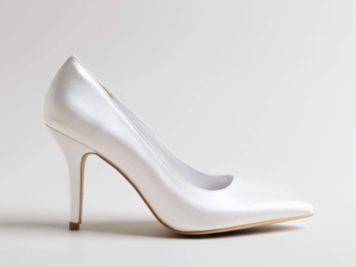White high-heeled shoe on a light gray background