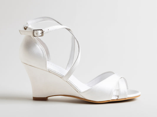 White wedge sandal on a light gray background