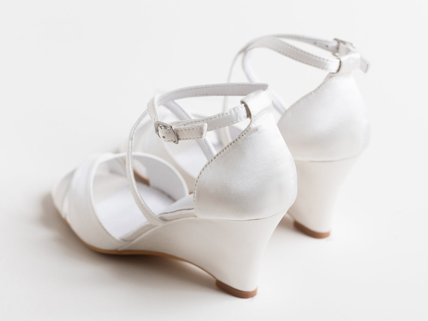 White wedding shoes with a strap on a light background