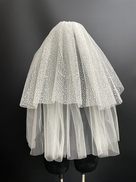 Vintage-inspired puffy bridal veil with glitter details, featuring a soft tulle design, showcased on a mannequin.