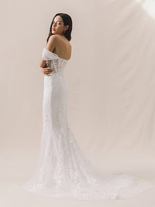 Woman in a white wedding dress with a plain background