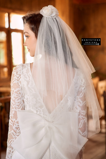 Back view of the fishtail lace wedding dress with a bow detail, showcasing the dramatic silhouette - Danystone Designs.