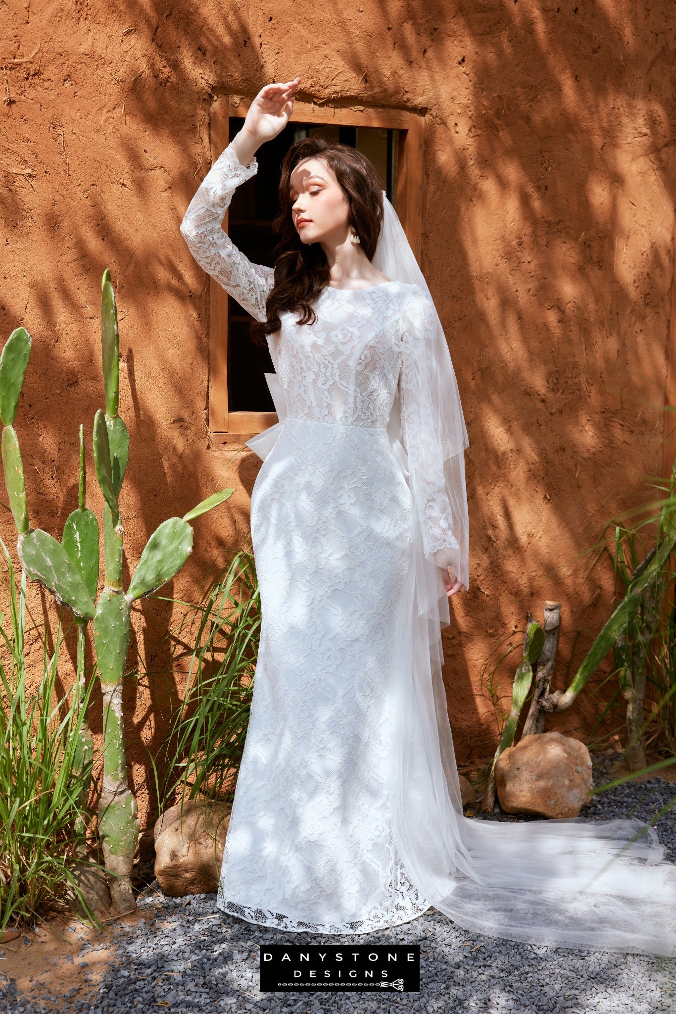 Full-length view of the elegant lace fishtail wedding dress with boat neck and bow back - Danystone Designs