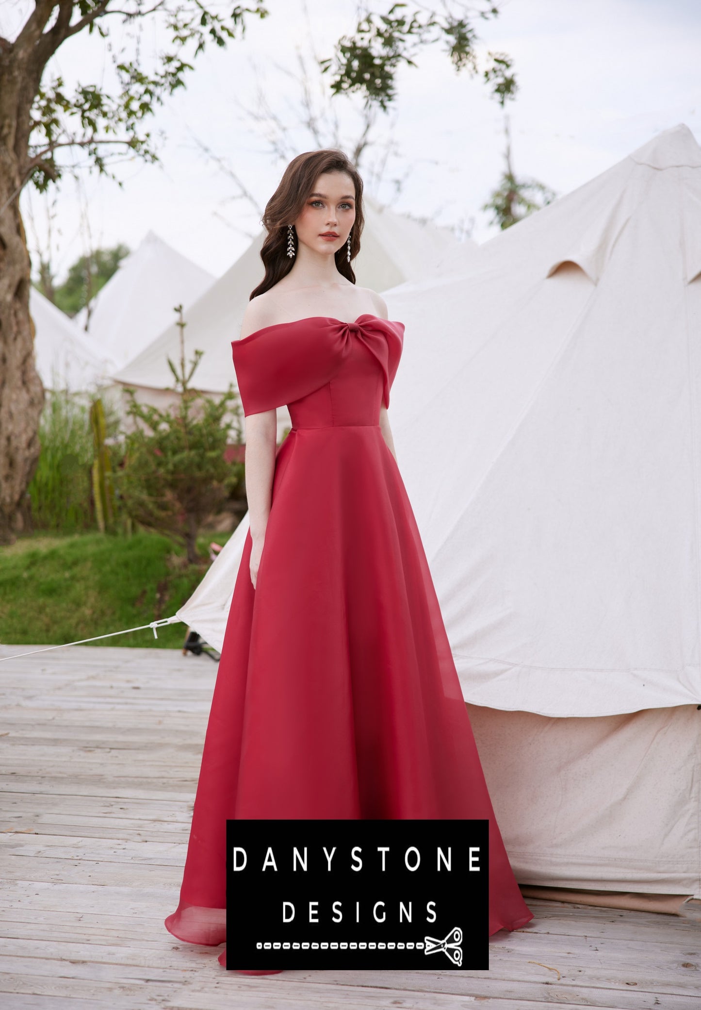 Elegant red silk chiffon dress with bow detail worn by a model