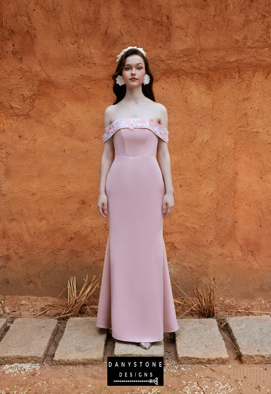 Model wearing an elegant pink off-shoulder satin fishtail dress with embossed flowers