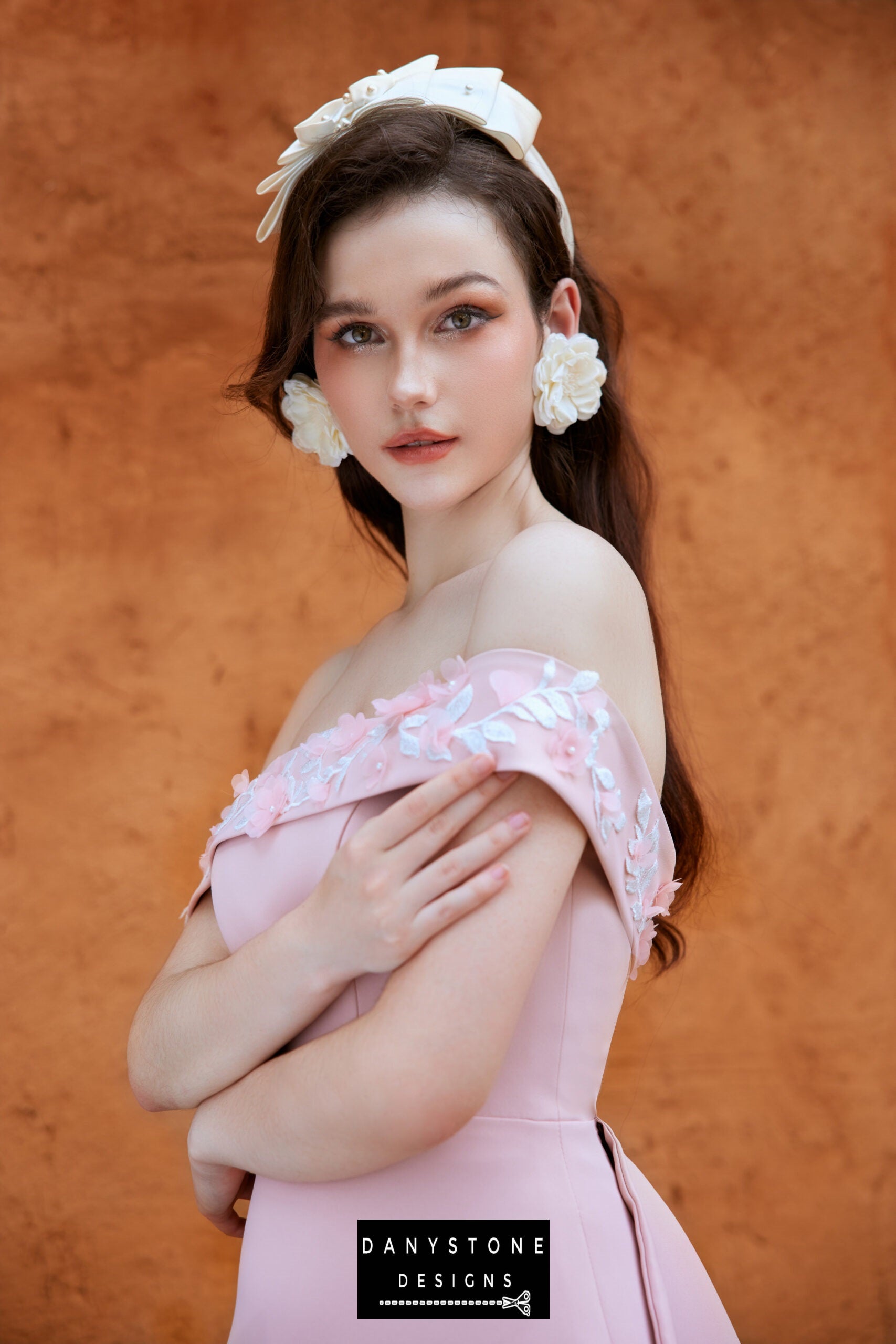 Elegant pink satin dress with off-shoulder neckline and embossed flowers