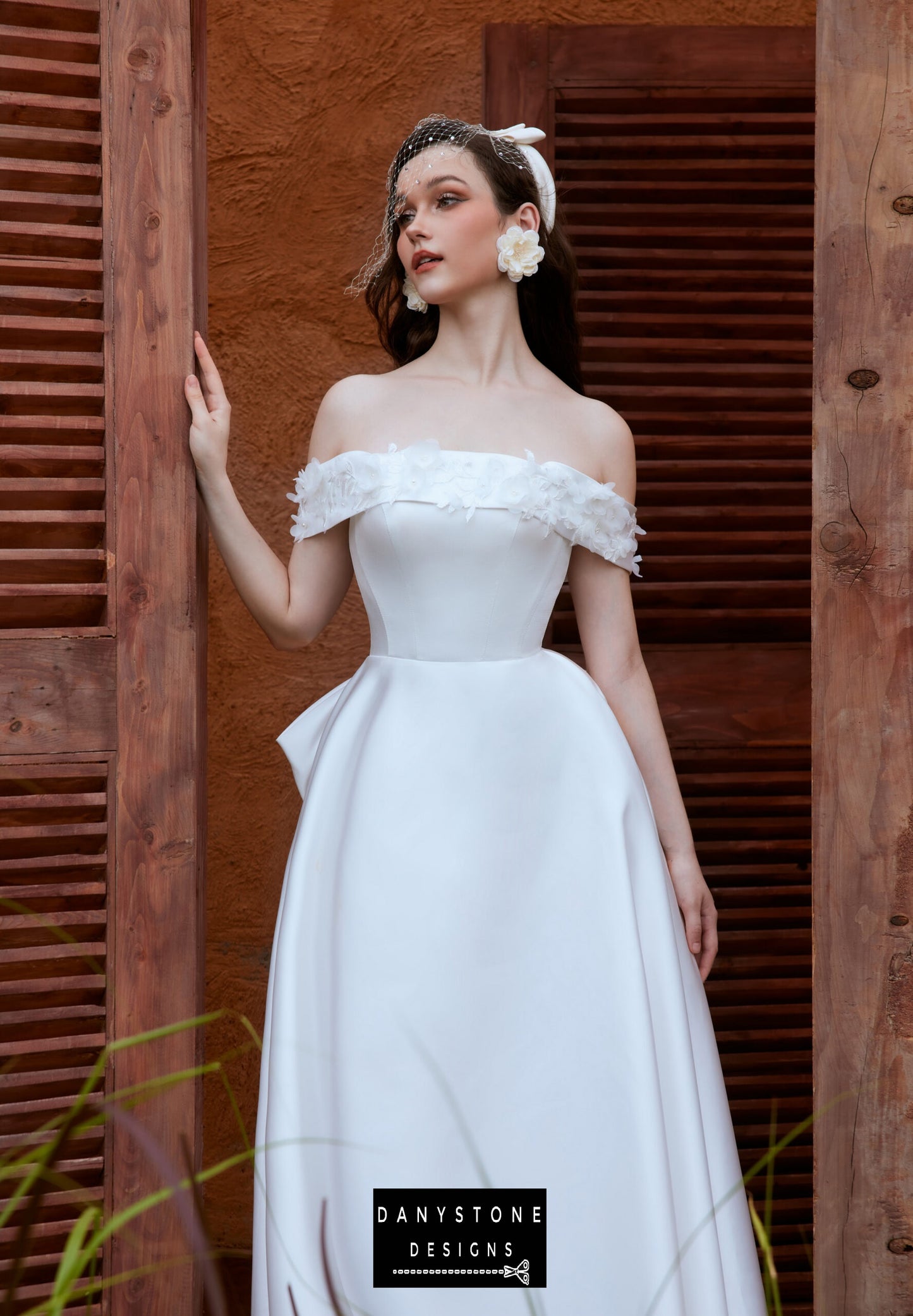 Full-length view of the off-the-shoulder wedding dress with floral accents - Danystone Designs.