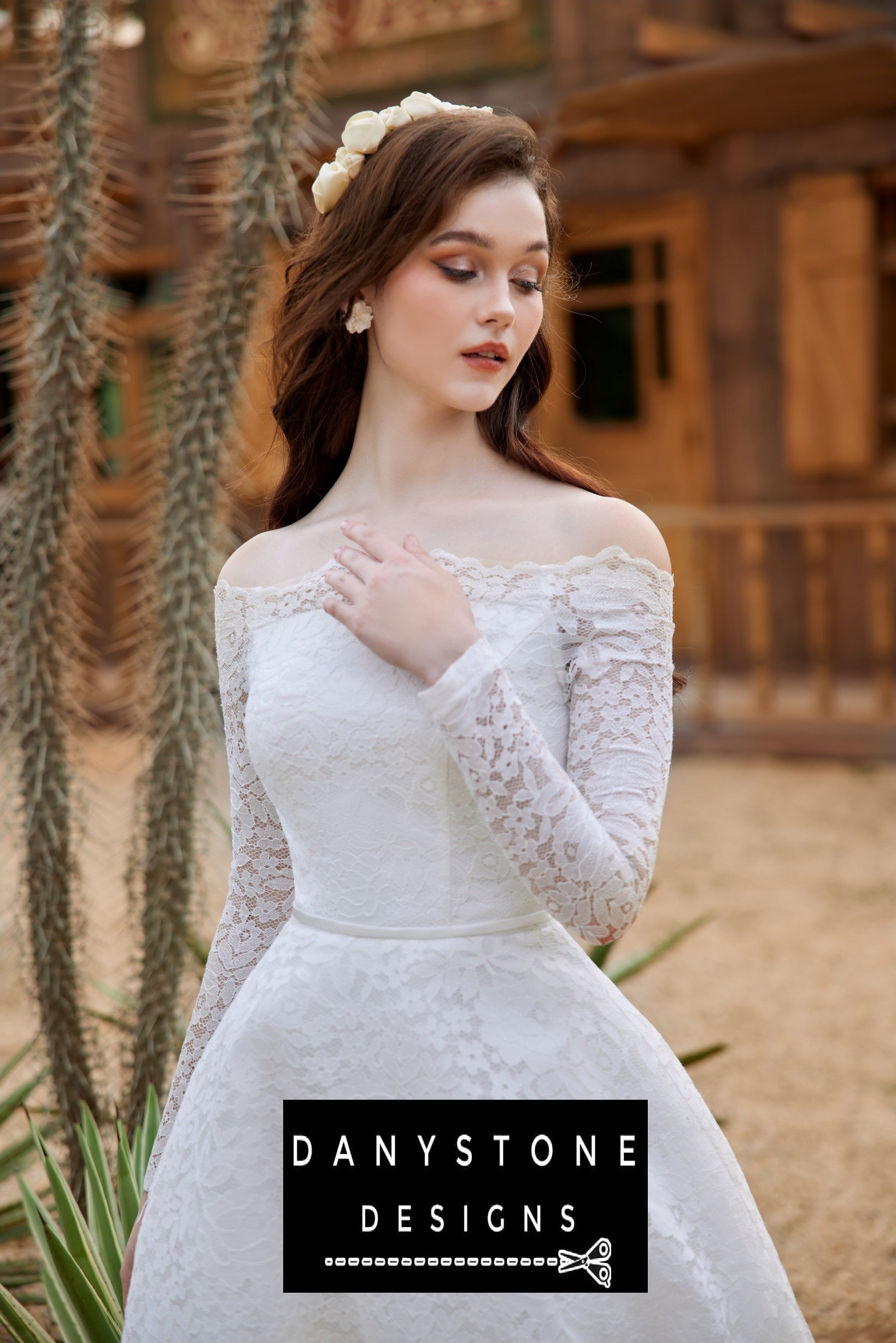 Close-up of the bride in a lace wedding dress with puffed shoulders, with a floral headpiece in her hair.