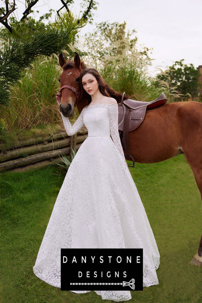 Bride wearing an elegant lace wedding dress with puffed shoulders, standing beside a horse in a lush garden.