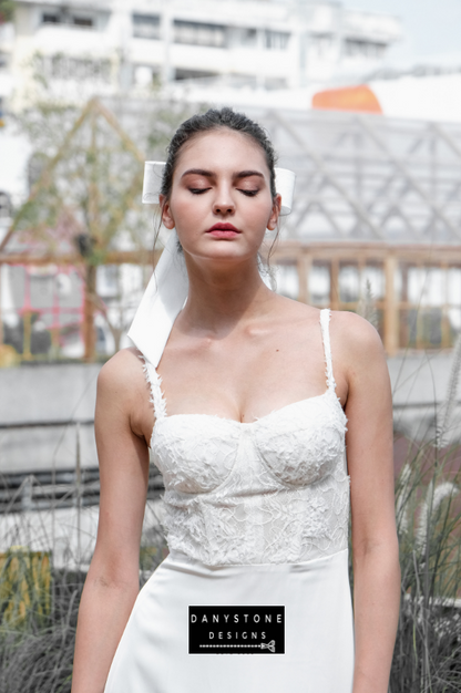 A close-up of the intricate 3D floral lace bodice on the satin dress.