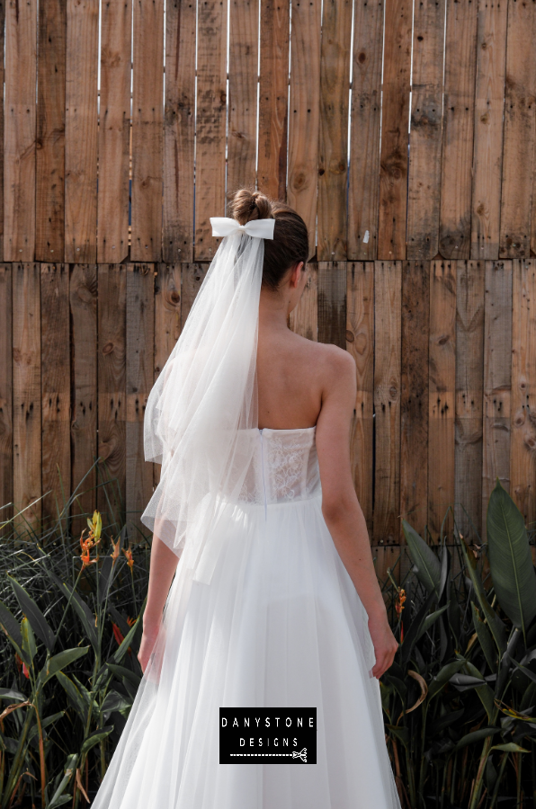 A back view highlighting the mesh fabric and elegant design of the mini dress.