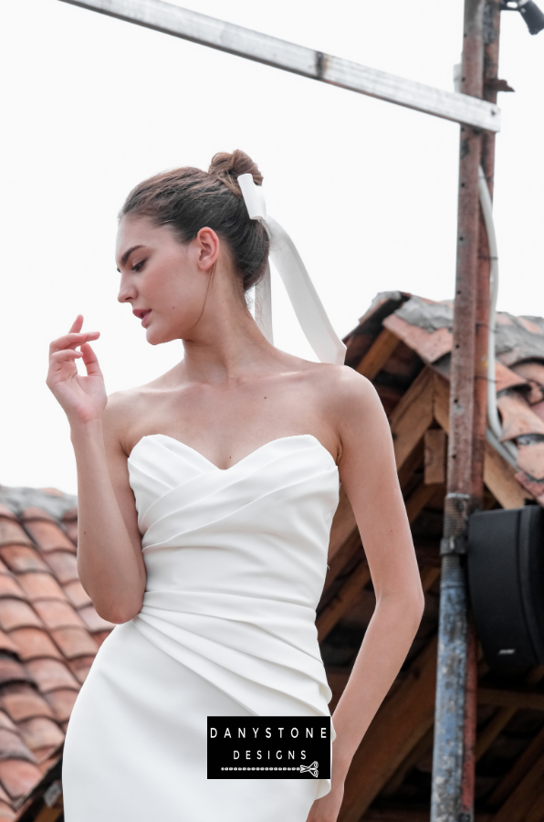 Pleated Strapless Bustier Gown - Close-up of the model highlighting the pleated strapless bustier and elegant design.