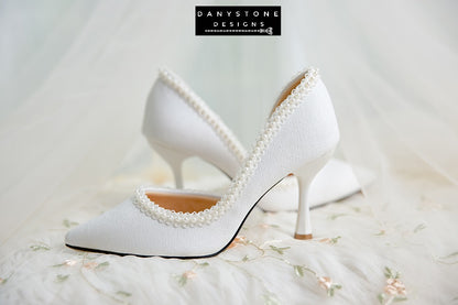 Wedding shoes with pearl trim, made from metallic scratched leather, featuring elegant heels.