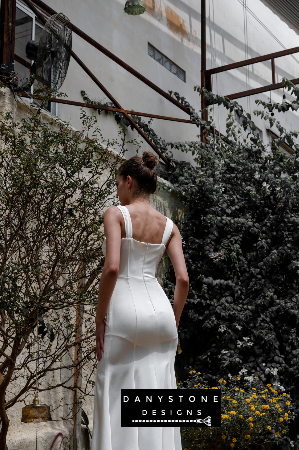 A side view of the elegant satin corset dress with lace detailing and high slits.