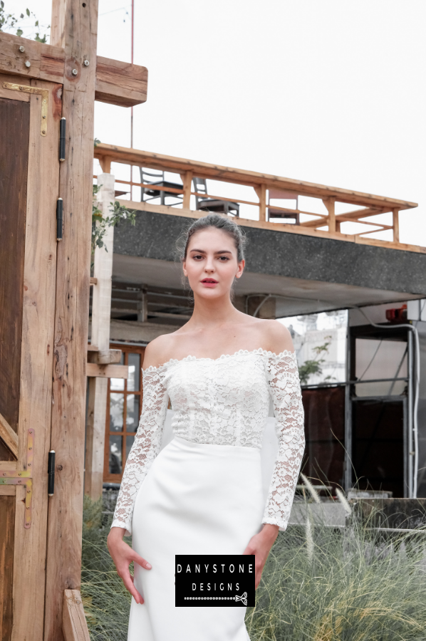 Model posing in the satin fishtail flat shoulder dress, showcasing the front design.