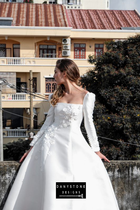  A side view of the elegant 7-piece tafta dress showcasing the embossed flowers and long sleeves.