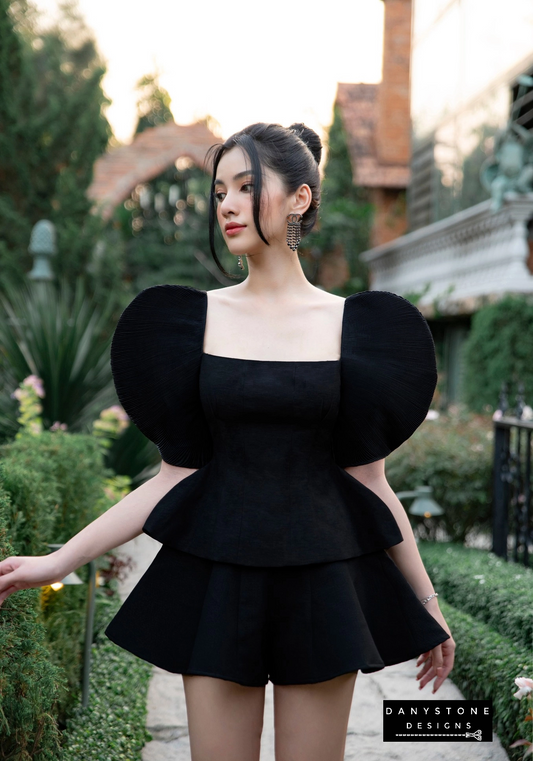 Back view of bold pleated puff sleeve shirt set in black