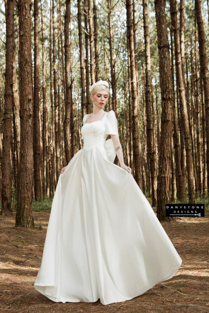 Sophisticated bridal gown with square neckline, short puff sleeves, and flowing skirt – Danystone Designs