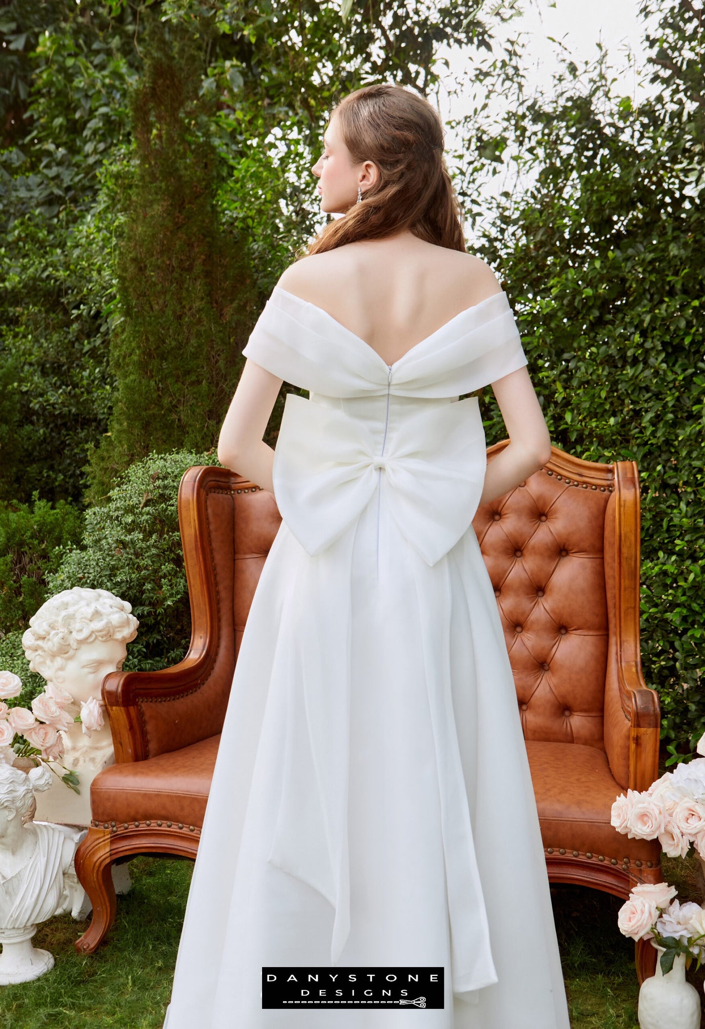 Enchanted Silk Chiffon Gown with Bow Detail - Back View - Model showcasing the off-the-shoulder neckline and elegant bow detail at the back of the gown.