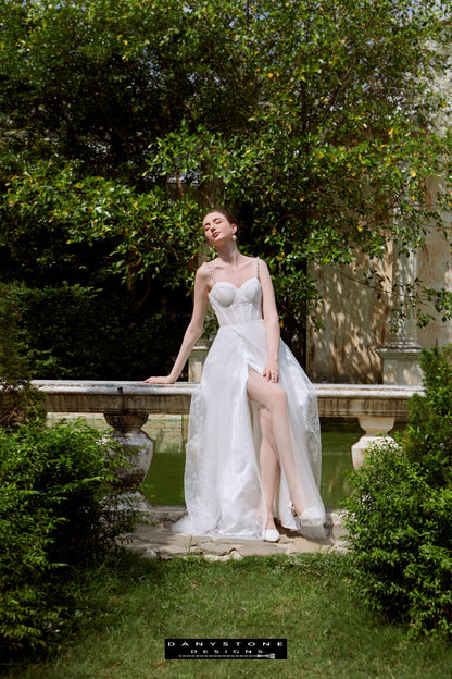 Cinderella Two-Strap Dress with Slit - Sitting Pose - Model posing sitting down in the Cinderella two-strap dress with a thigh-high slit, exuding elegance and allure.