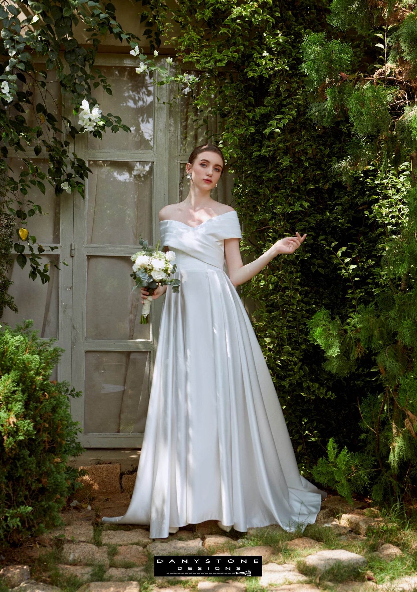 Timeless Cross-Breasted Wedding Dress - Model standing gracefully in the cross-breasted dress with pleated bow, showcasing the luxurious fabric and elegant design.