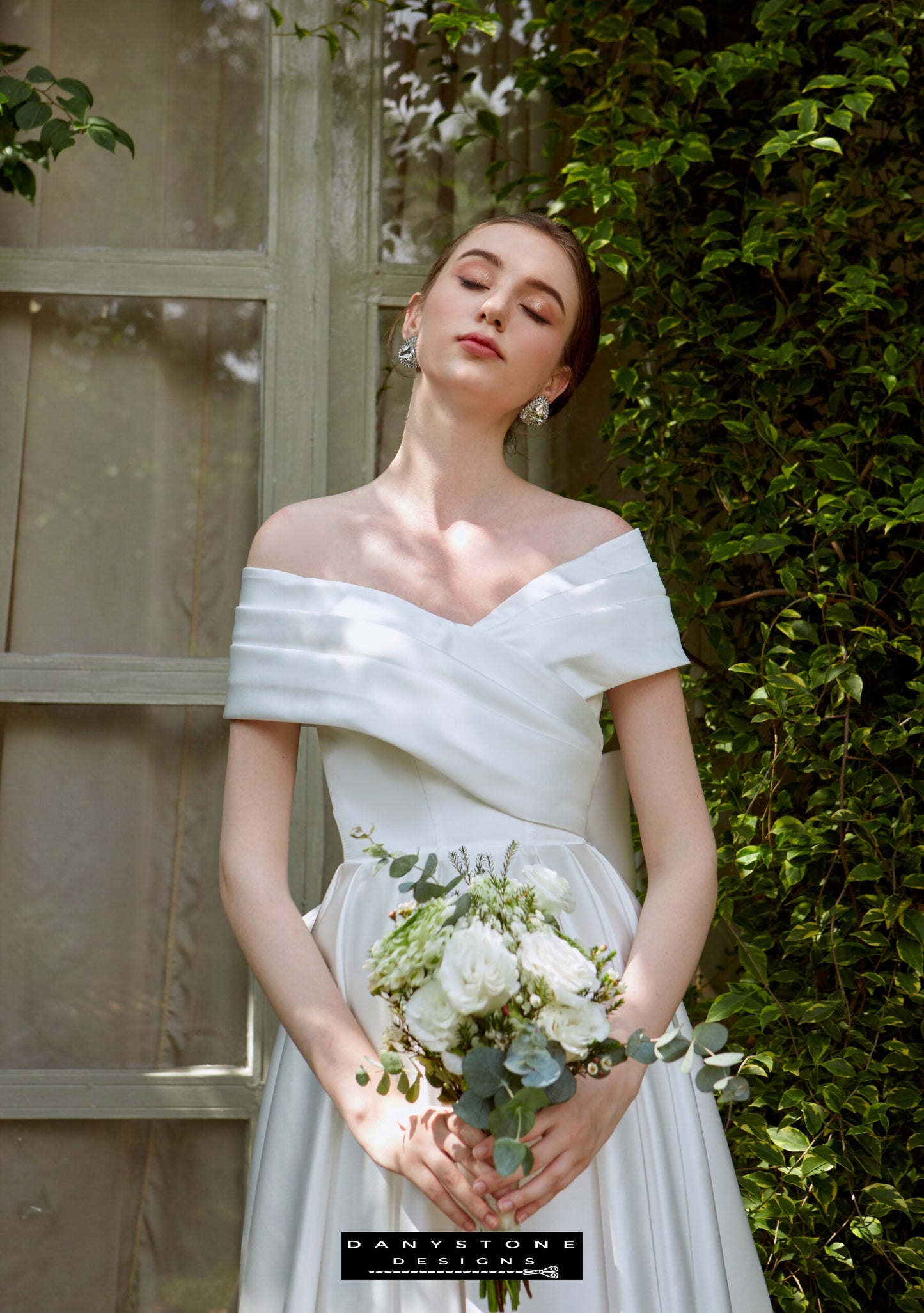 Cross-Breasted Dress with Pleated Bow - Front View - Model showcasing the front view of the cross-breasted dress with a pleated bow at the back, holding a bouquet.