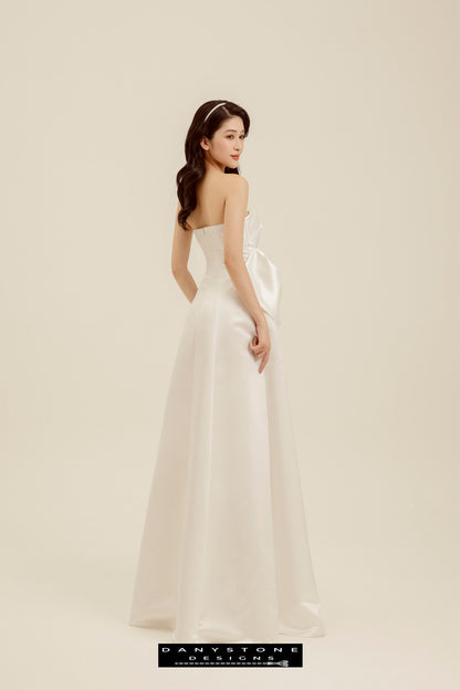 Back view of strapless wedding gown with bow detail and flowing silhouette – Danystone Designs