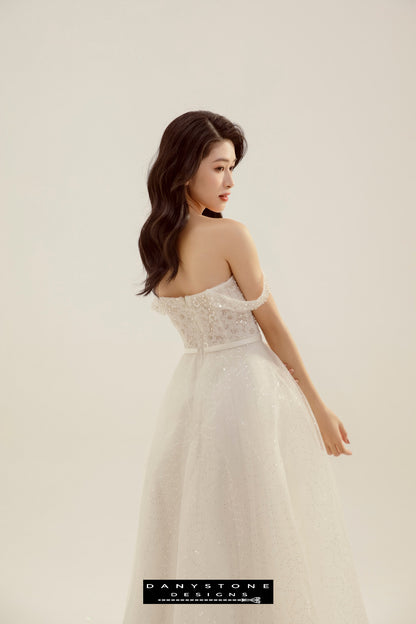 Elegant Puffy Flower Dress - Side View - Model displaying the side view of the dress, highlighting the delicate puffy flowers and flat shoulder design.