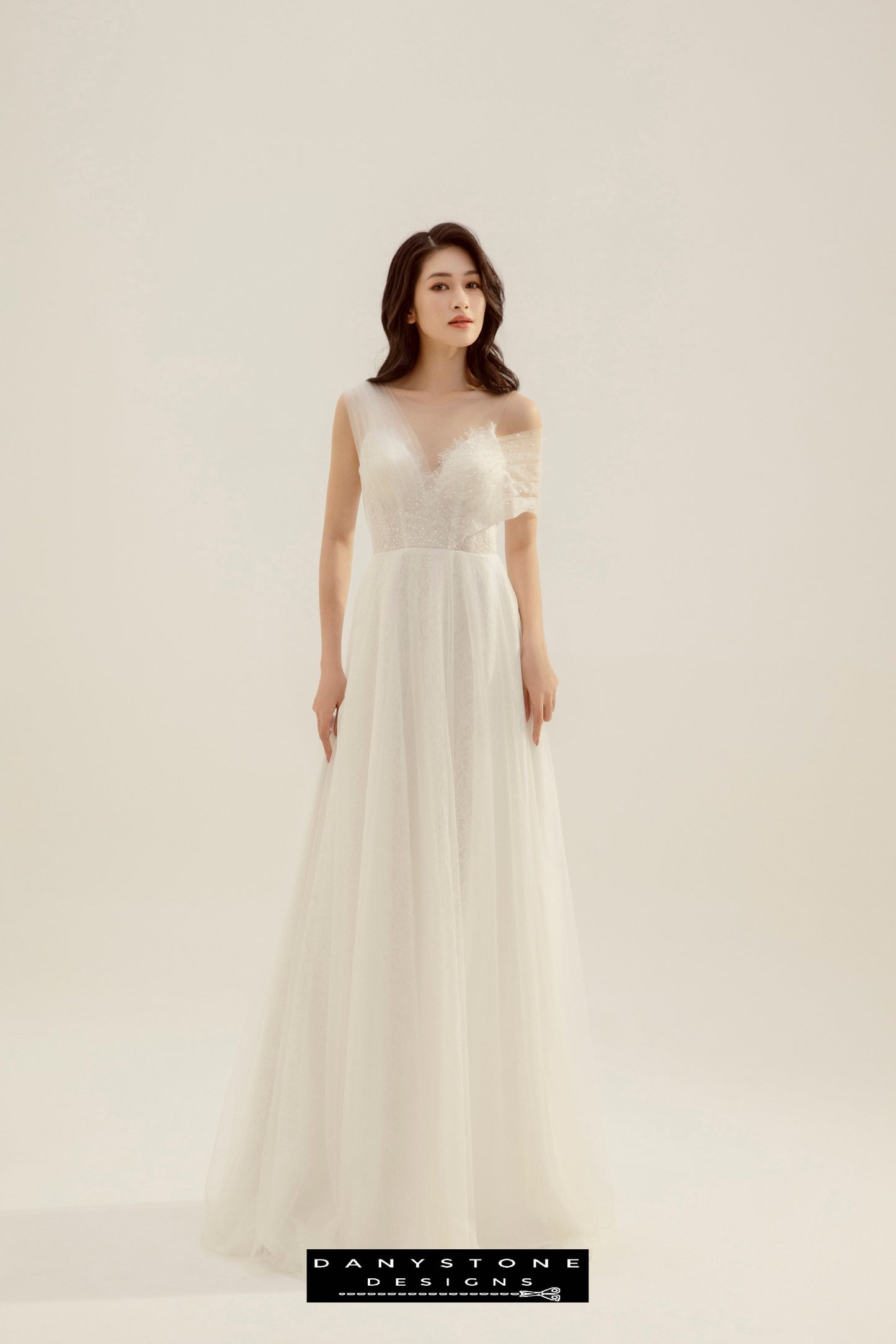 Full-length view of the model in the Beaded Floral Lace Pleated Wedding Dress, front pose.