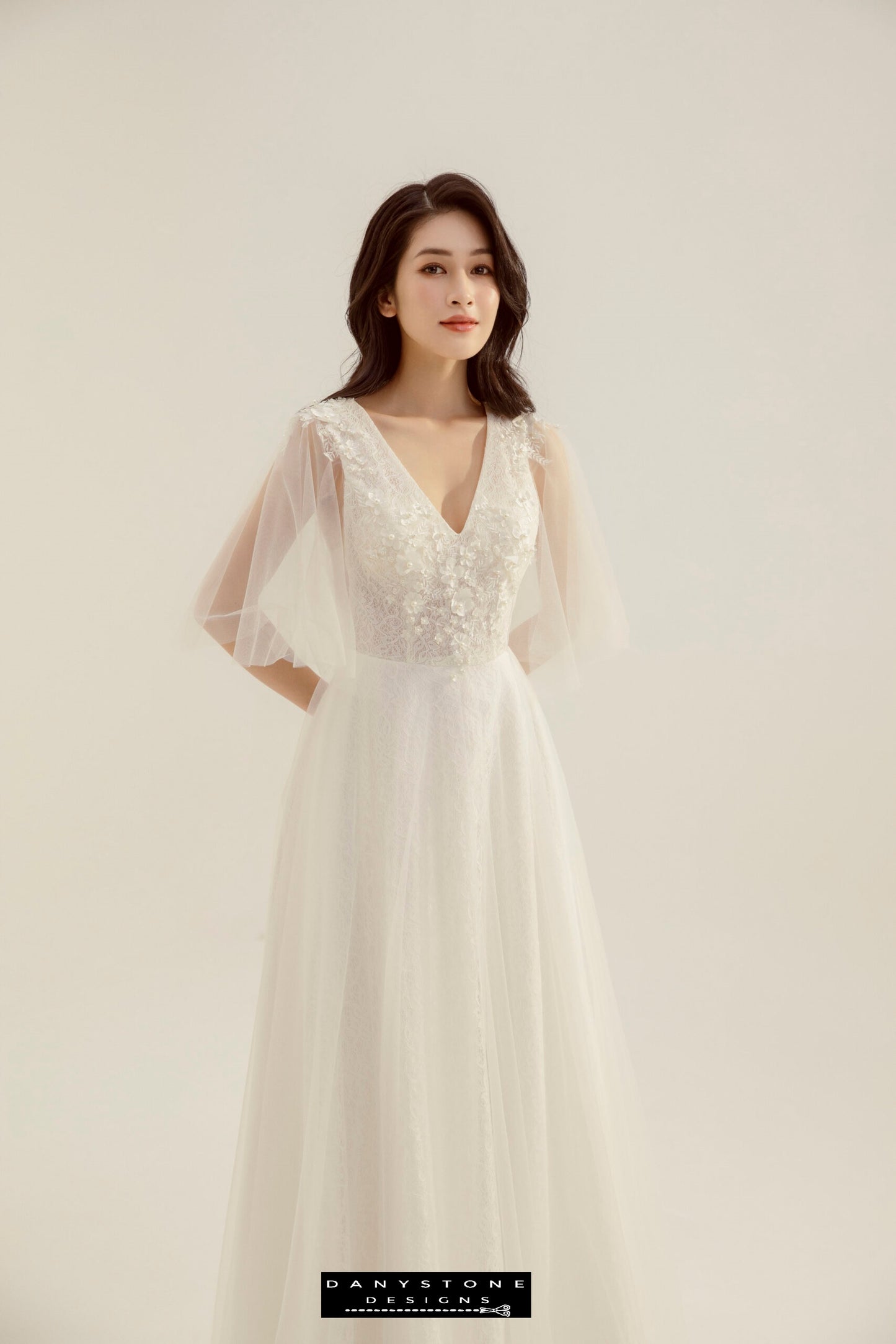 Bride in a lace wedding dress with heart collar and fairy petals, looking elegant and poised.