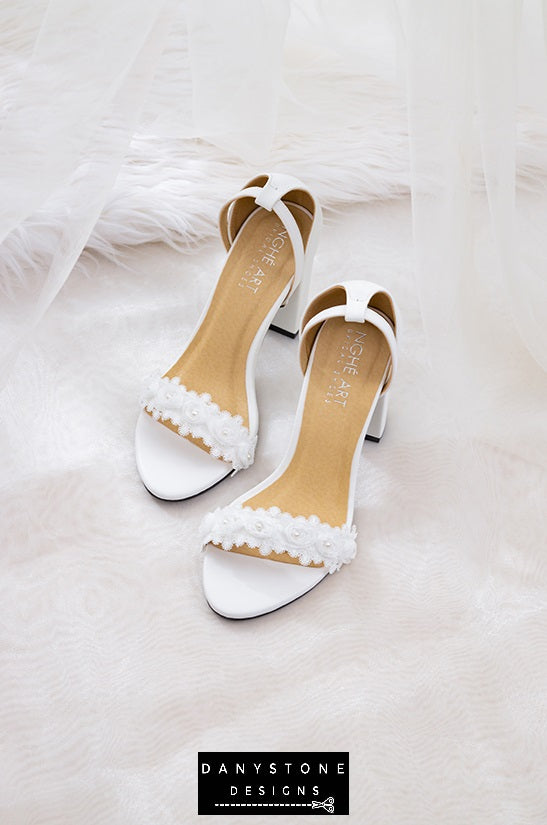 Front view of matte white leather heels with white rose lace trim, perfect for bridal wear.